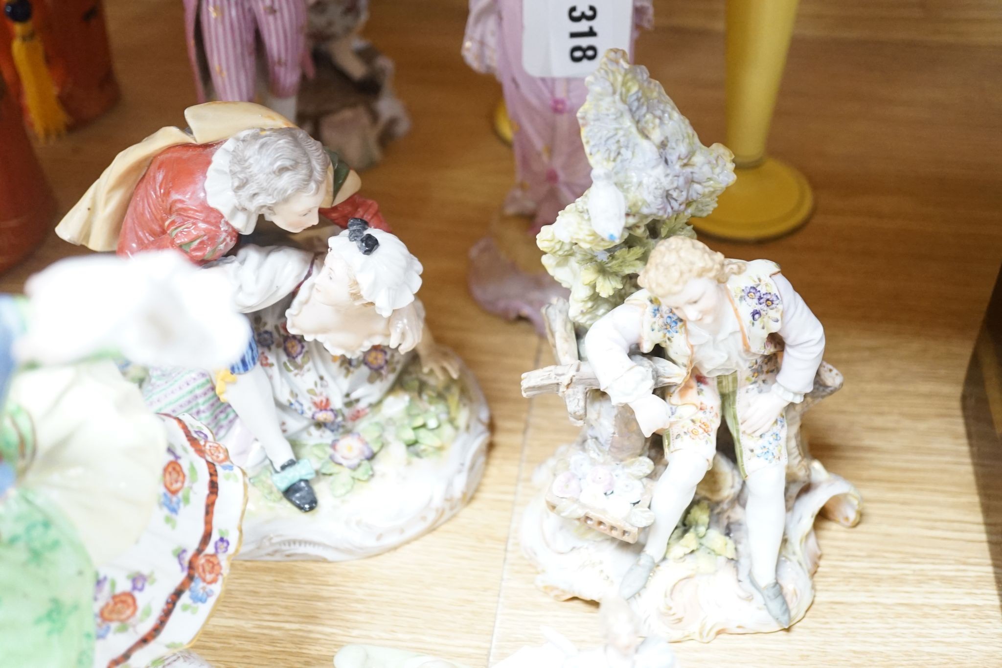 A collection of German and French porcelain figurines, Coalport commemorative urn etc.